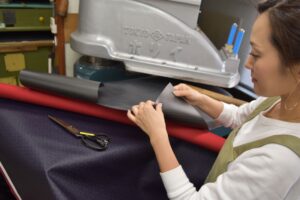 Gozen bag manufacturing — skilled artisans hand-assembling bags in Japanese atelier